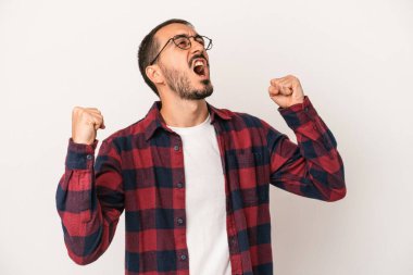 Beyaz arka planda izole edilmiş genç beyaz bir adam zaferden sonra yumruğunu kaldırıyor, kazanan konsept.