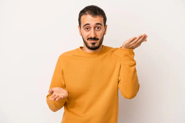 Young Caucasian Man Isolated White Background Makes Scale Arms Feels — Stock Photo, Image