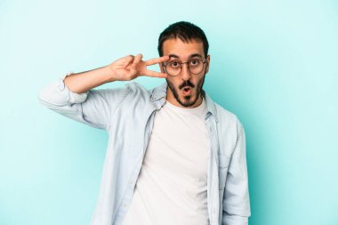 Genç beyaz adam mavi arka planda izole edilmiş dans ediyor ve eğleniyor..