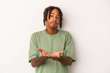 Beyaz arka planda izole edilmiş genç Afro-Amerikan bir adam elinde avuç içi bir şeyle kameraya teklif ediyor..
