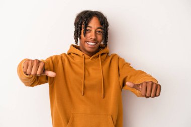 Genç Afrikalı Amerikalı adam beyaz arka planda izole edilmiş. Baş parmağını kaldırıyor, gülümsüyor ve kendinden emin..