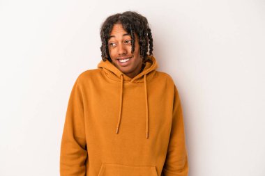 Beyaz arka planda izole edilmiş genç Afrikalı Amerikalı adam gülüyor ve gözlerini kapıyor, rahatlamış ve mutlu hissediyor..