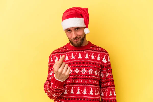 Молодий Кавказький Чоловік Святкує Різдво Ізольовано Жовтому Тлі Вказуючи Пальцем — стокове фото