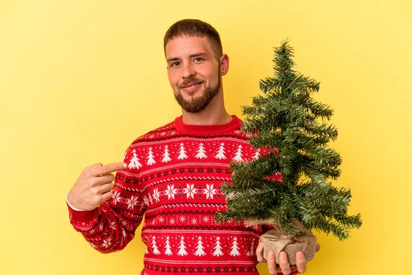 Ung Kaukasier Man Köpa Liten Gran Till Jul Isolerad Gul — Stockfoto