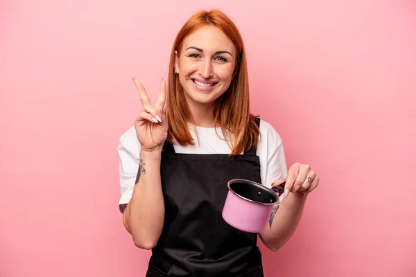 Young Caucasian Cooker Woman Holding Translator Isolated Pink Background Showing — Stock Photo, Image