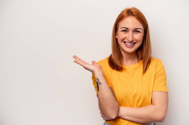 Beyaz arka planda izole edilmiş genç beyaz kadın bir avuç içinde fotokopi alanı ve belinde bir el daha gösteriyor..