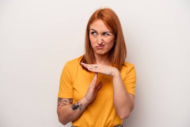 Beyaz arka planda izole edilmiş genç beyaz kadın bir mola hareketi gösteriyor..