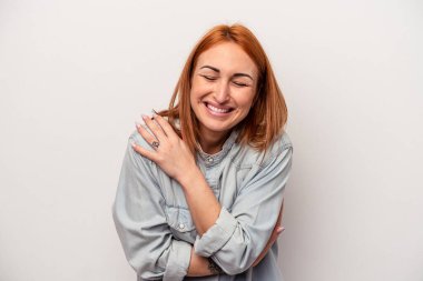 Beyaz arka planda izole genç beyaz kadın gülüyor ve eğleniyor..