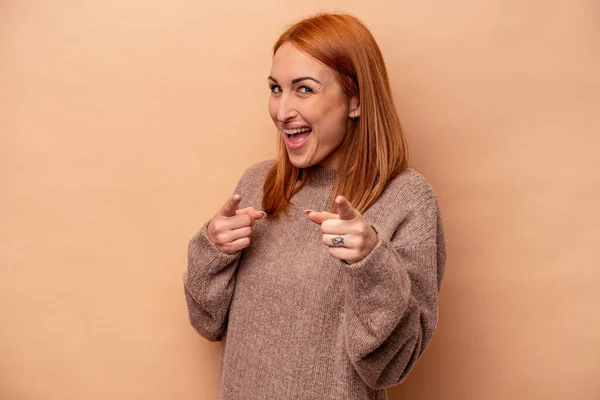 Mujer Joven Caucásica Aislada Sobre Fondo Beige Apuntando Hacia Delante —  Fotos de Stock