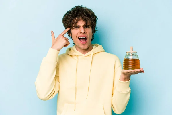 Young Caucasian Man Holding Honey Isolated Blue Background Showing Disappointment — Stock Photo, Image