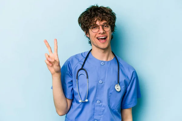 Young Caucasian Nurse Man Isolated Blue Background Showing Number Two — Stock Photo, Image