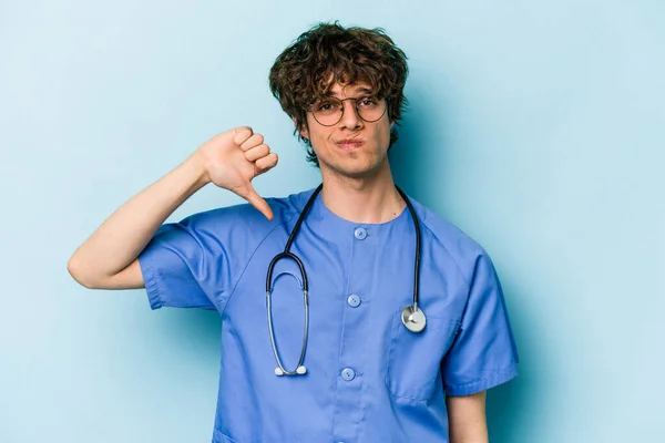 Young Caucasian Nurse Man Isolated Blue Background Showing Dislike Gesture — Stock Photo, Image