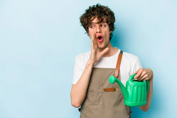 Young Gardener Caucasian Man Holding Watering Can Isolated Blue Background — Foto de Stock