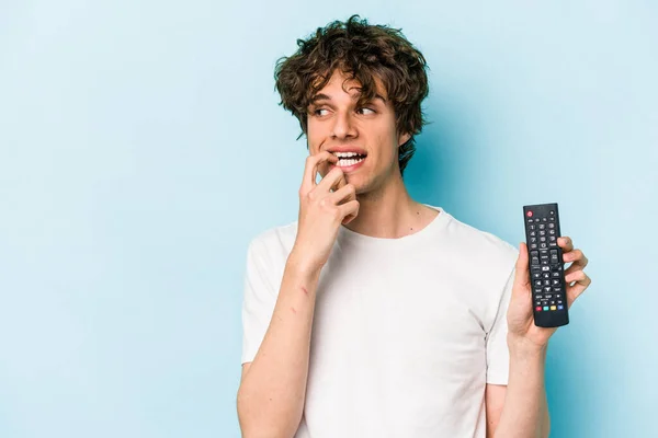 Young Caucasian Man Holding Controller Isolated Blue Background Relaxed Thinking — 스톡 사진