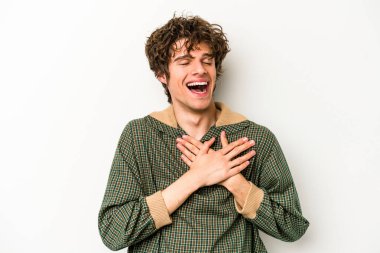 Beyaz arka planda izole edilmiş beyaz tenli genç bir adam, dostane bir ifadeye sahip, avuçlarını göğsüne bastırıyor. Aşk konsepti.