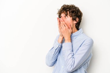 Beyaz arka planda izole edilmiş beyaz tenli genç adam ağzını eliyle kapatan bir fotokopi odasına bakıyor..