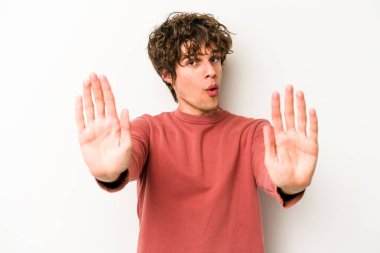 Beyaz arka planda izole edilmiş genç beyaz bir adam elini uzatmış, dur işareti göstererek seni engelliyor..