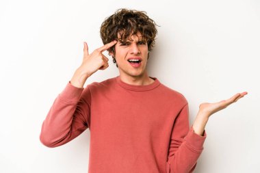 Beyaz arka planda izole edilmiş genç beyaz bir adam işaret parmağıyla hayal kırıklığı jesti gösteriyor..