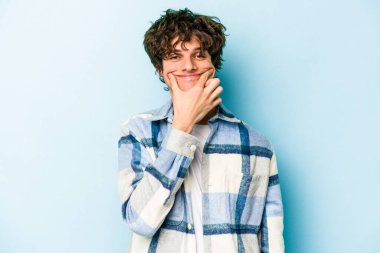 Kafkasyalı genç adam mavi arka planda izole edilmiş iki seçenek arasında şüphe duyuyor.