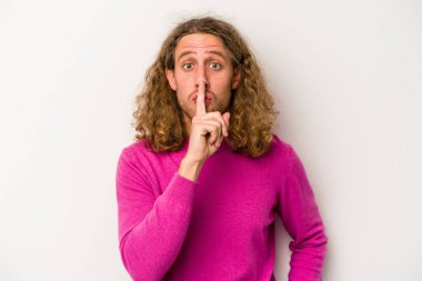 Beyaz arka planda izole edilmiş genç beyaz bir adam ya sır saklıyor ya da sessizlik istiyor..