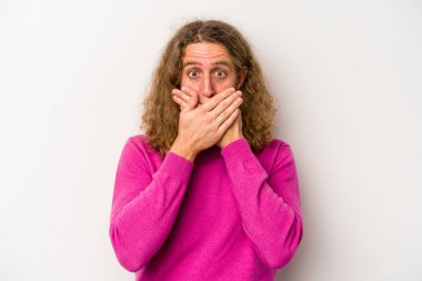 Beyaz arka planda izole edilmiş genç beyaz bir adam ağzı kapalı ve elleri endişeli görünüyor..