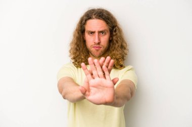 Beyaz arka planda izole edilmiş genç beyaz bir adam elini uzatmış, dur işareti göstererek seni engelliyor..