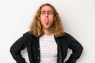 Beyaz arka planda izole edilmiş genç beyaz bir adam. Komik ve dost canlısı bir dil uzatıyor..