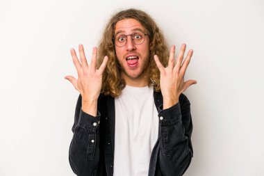 Beyaz arka planda izole edilmiş beyaz tenli genç adam on numarayı elleriyle gösteriyor..