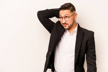 İspanyol iş adamı beyaz arka planda izole edilmiş kafasının arkasına dokunuyor, düşünüyor ve bir seçim yapıyor..