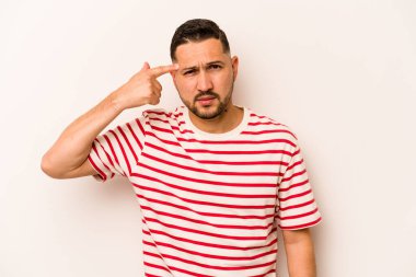 Beyaz arka planda izole edilmiş genç İspanyol adam işaret parmağıyla bir hayal kırıklığı gösteriyor..