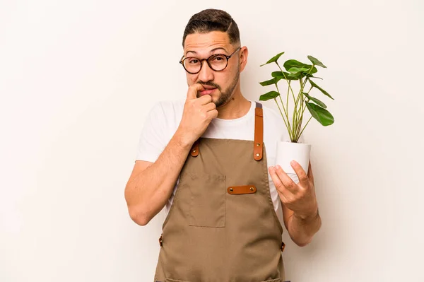 Hispanic Gardener Man Holding Plant Isolated White Background Biting Fingernails — Foto Stock