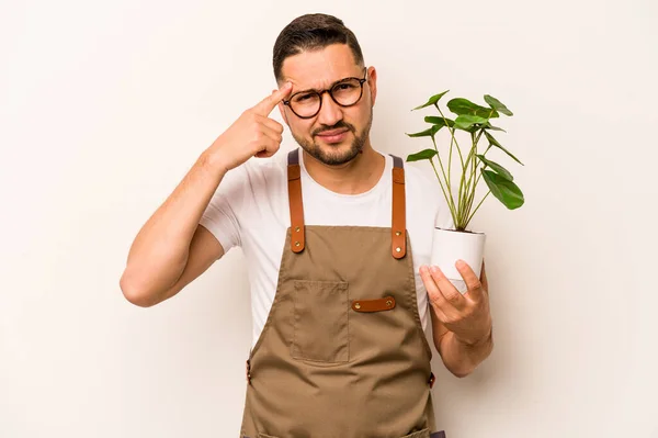 Hispanic Gardener Man Holding Plant Isolated White Background Showing Disappointment — Foto Stock