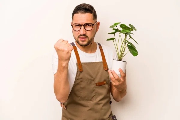 Hispanic Gardener Man Holding Plant Isolated White Background Showing Fist — Foto Stock