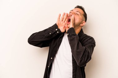 Beyaz arka planda izole edilmiş genç İspanyol adam heyecanlı bir şekilde bağırıyor..