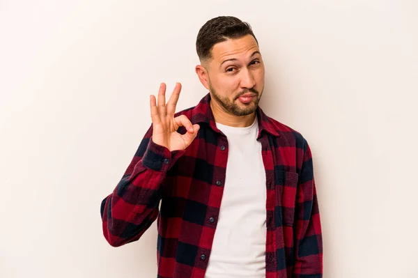 Young Hispanic Man Isolated White Background Winks Eye Holds Okay — ストック写真