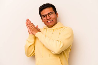 Beyaz arka planda izole edilmiş genç İspanyol adam enerjik ve rahat hissediyor, ellerini ovuşturuyor..