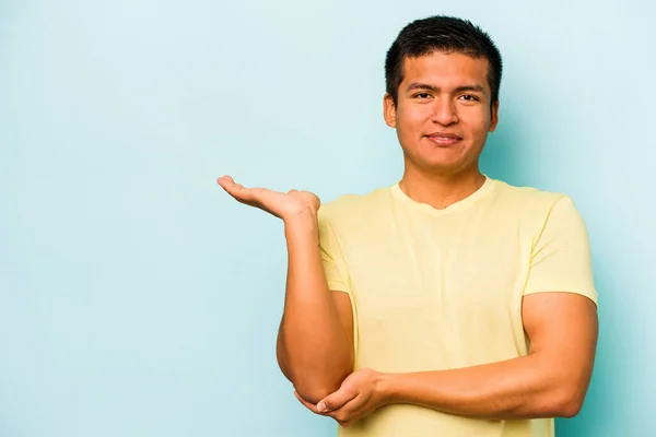 Young Hispanic Man Isolated Blue Background Showing Copy Space Palm — стоковое фото