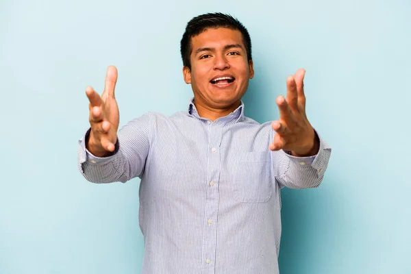 Young Hispanic Man Isolated Blue Background Feels Confident Giving Hug — Stock Photo, Image