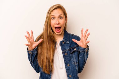 Beyaz arka planda izole edilmiş genç beyaz kadın gökyüzüne haykırıyor, yukarı bakıyor, hayal kırıklığına uğramış..