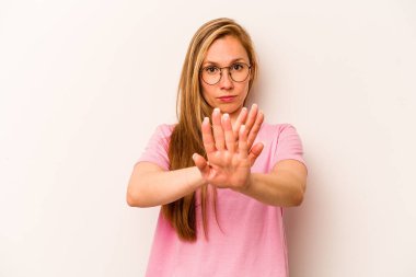Beyaz arka planda izole edilmiş genç beyaz bir kadın elini uzatmış, dur işareti göstererek seni engelliyor..