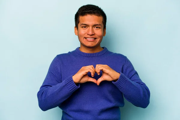 Young Hispanic Man Isolated Blue Background Smiling Showing Heart Shape — стоковое фото