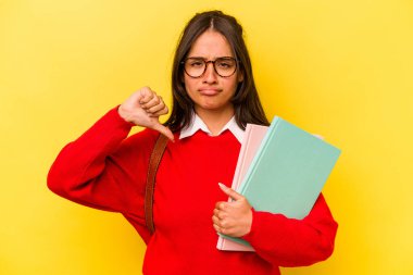 Sarı arka planda izole edilmiş, hoşlanmadığı bir hareket gösteren genç İspanyol öğrenci. Anlaşmazlık konsepti.