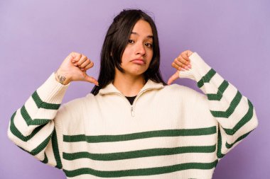 Mor arka planda izole edilmiş genç İspanyol kadın gururlu ve kendinden emin hissediyor, örnek olarak.