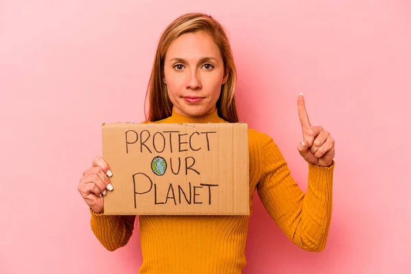 Young Caucasian Woman Holding Protect Our Planet Placard Isolated Pink — Photo