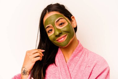 Beyaz arka planda izole edilmiş yüz maskesi takan genç İspanyol kadın.