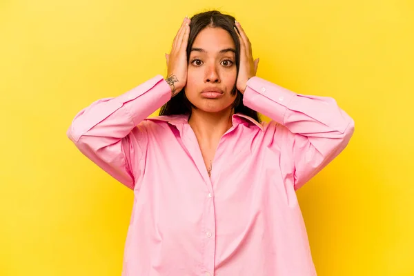 stock image Young hispanic woman isolated on yellow background being shocked, she has remembered important meeting.