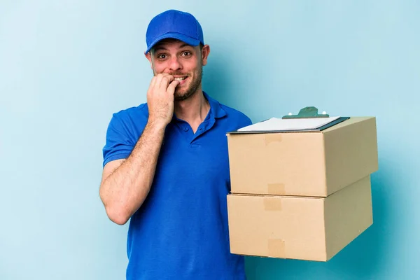 Young Caucasian Delivery Man Isolated Blue Background Biting Fingernails Nervous — Foto de Stock