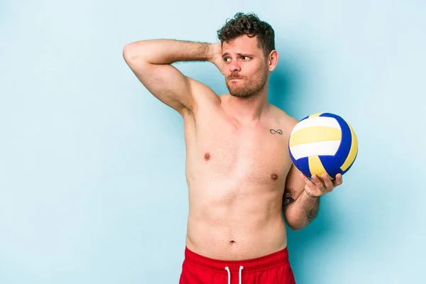 Young Caucasian Man Playing Volley Isolated Blue Background Touching Back — Stok fotoğraf