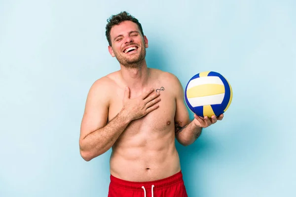 Young Caucasian Man Playing Volley Isolated Blue Background Laughs Out — Photo