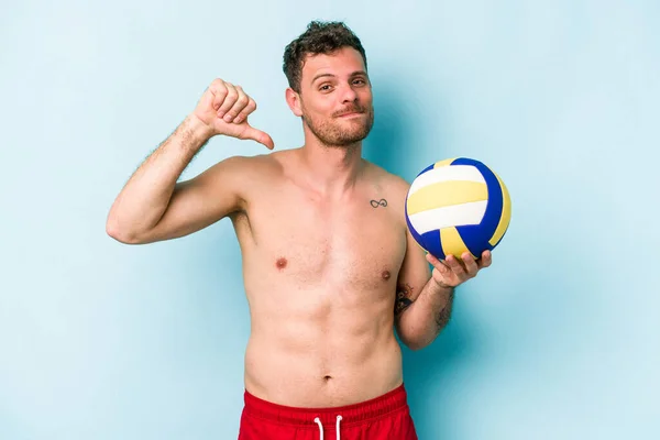 Young Caucasian Man Playing Volley Isolated Blue Background Feels Proud — Stok fotoğraf